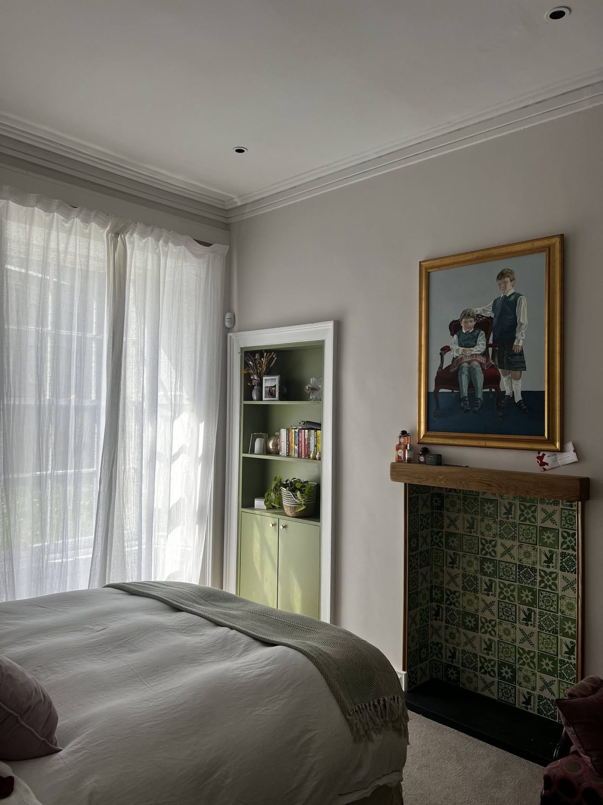 Bedroom with lined walls painted soft blush pink, white cornicing and a sage green alcove cabinet, Grove Street, Edinburgh