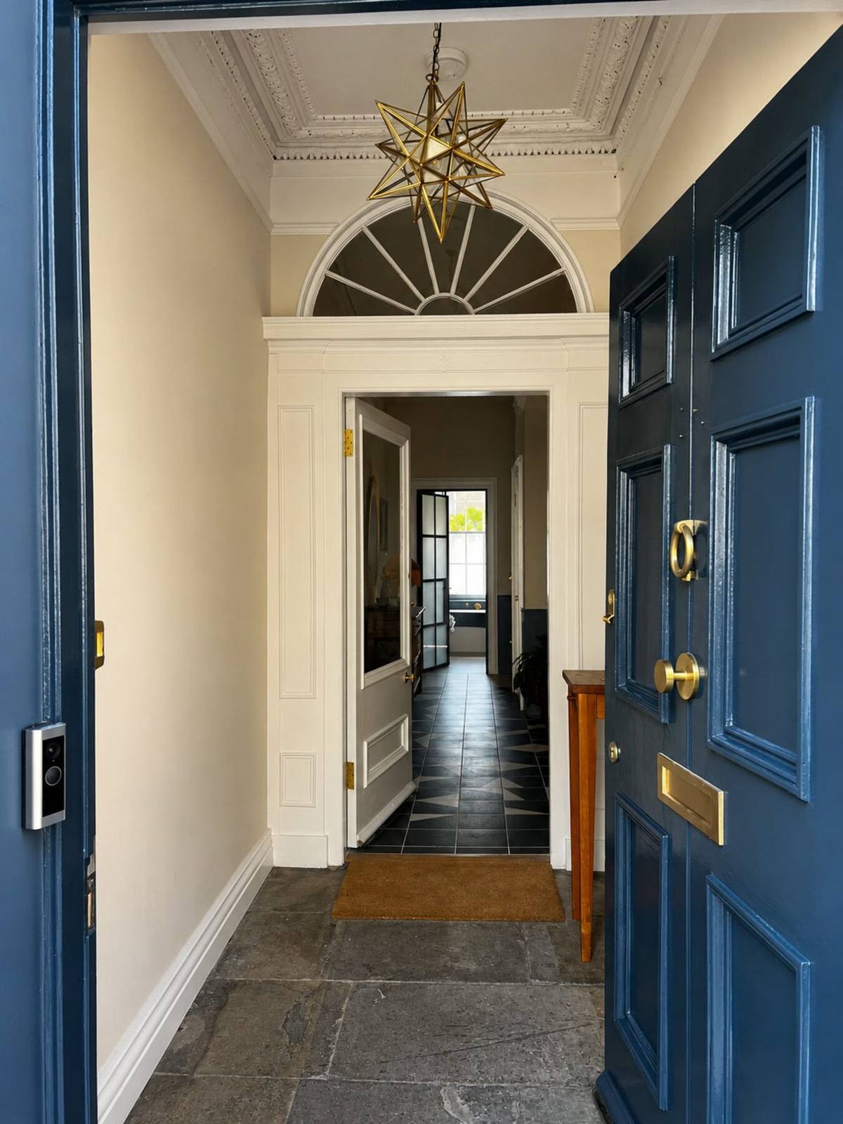 Freshly painted navy front door and hallway of a period Edinburgh property